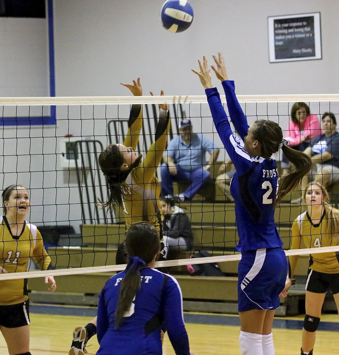 Image: Bailey Eubank(1) pushes the ball up and over as senior Paige Westbrook(11) stays vocal and Halee Turner(4) remains at the ready.