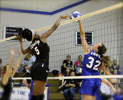 Image: JV Lady Gladiator Janae Robertson(5) tries to win the joust at the net against Frost.