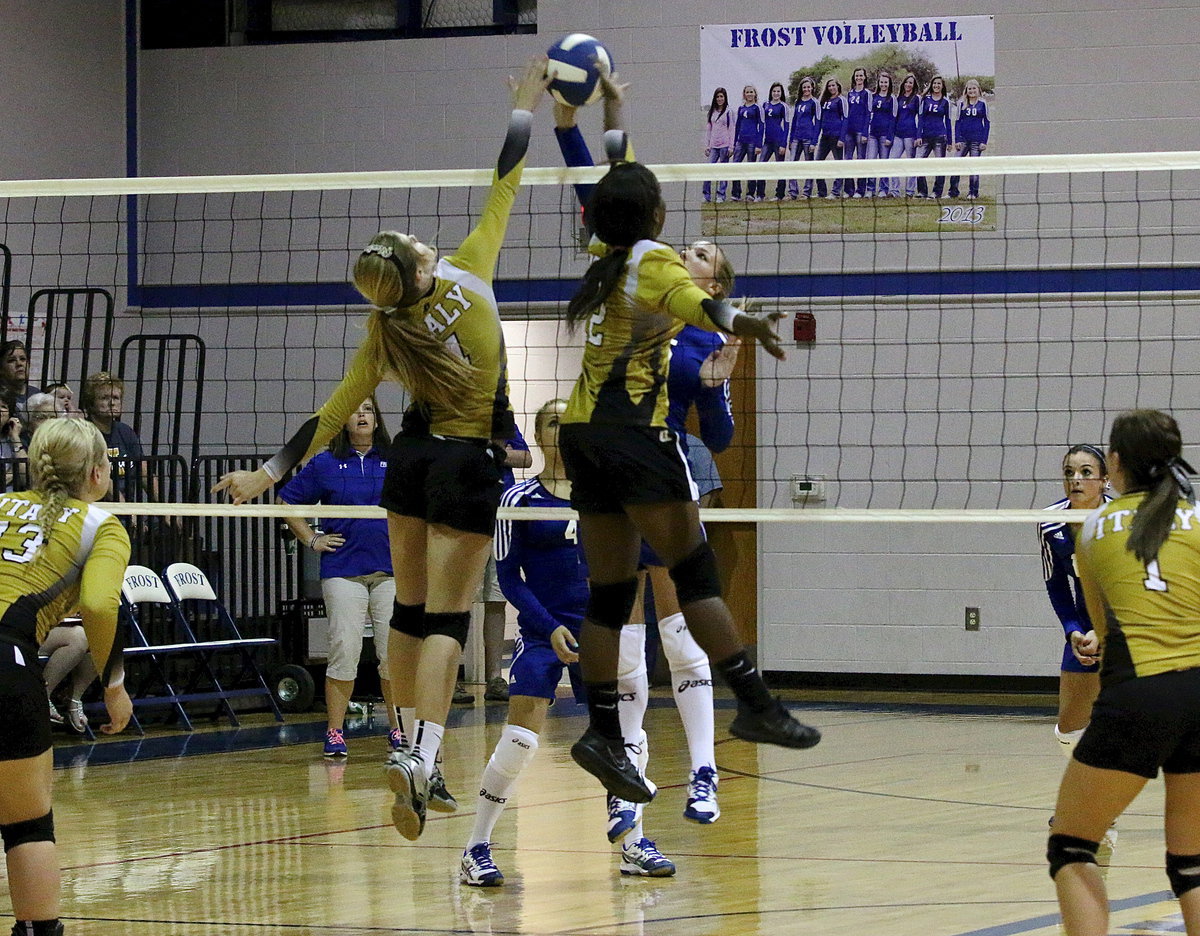 Image: Halee Turner(4) and Kortnei Johnson(12) team up for Italy to block a Frost player.