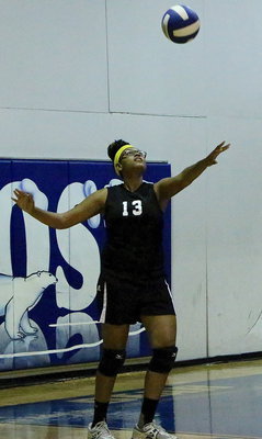 Image: JV Lady Gladiator Oleshia “Miss O” Anderson(13) serves the ball back over to Frost.