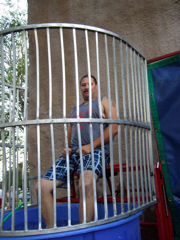 Image: Milford Police Chief Carlos Phoenix is quite a sport taking his turn in the dunking booth.