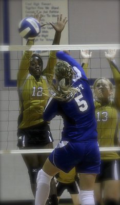 Image: Kortnei Johnson(12) and Jaclynn Lewis(13) are defiant at the net.