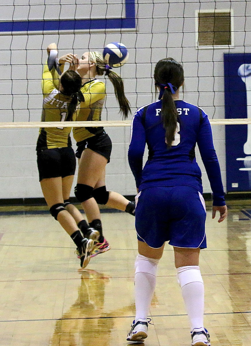 Image: The effort was there as Bailey Eubank(1) and Madison Washington(10) hustle after a ball but Frost stood strong for a 3 set sweep during the varsity game.