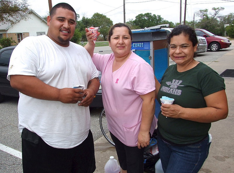 Image: Francisco Perez, Maria Lopez and Elena Barragan took great pride in serving snow cones and cotton candy during the yearbook signing.