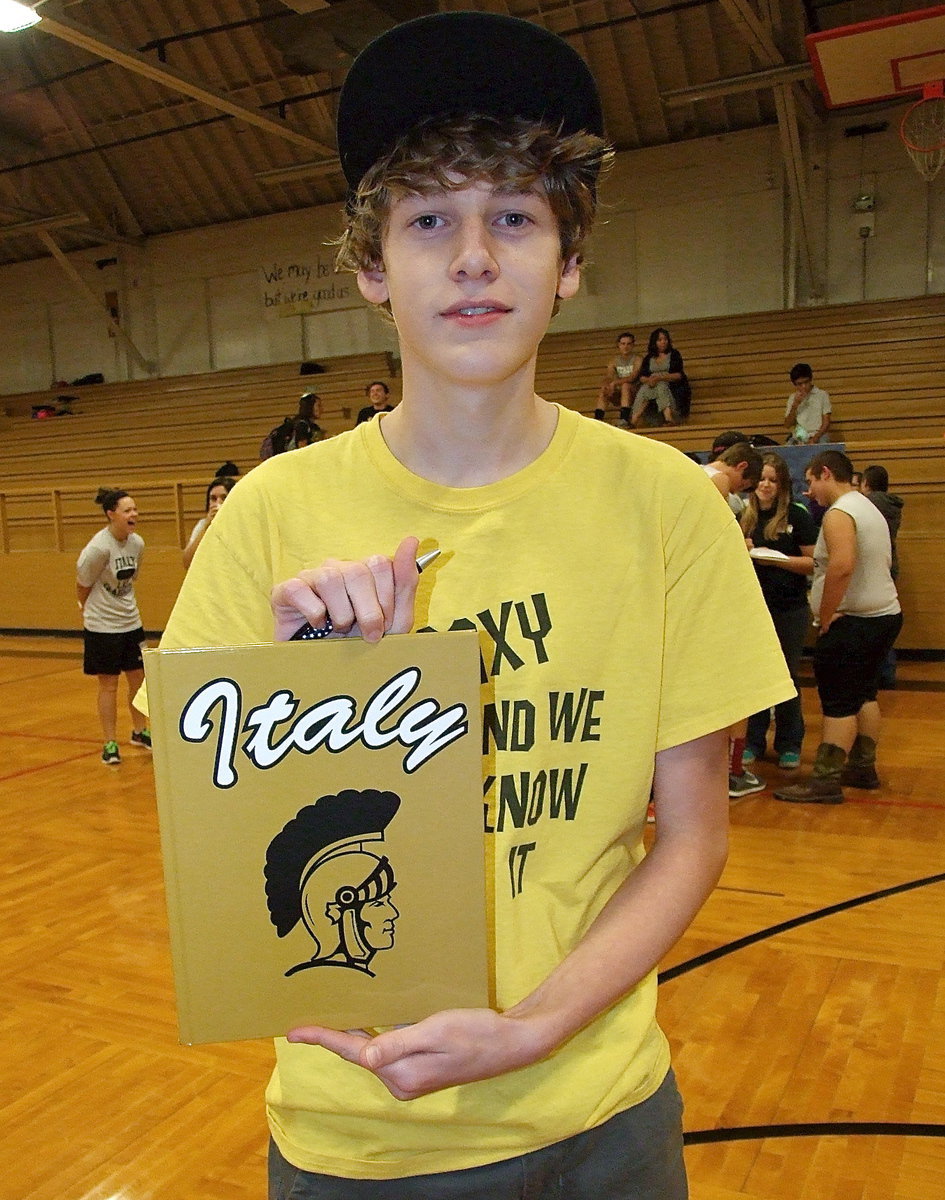 Image: Displaying the 2012-2013 edition of The Gladiator yearbook is Michael Moore.