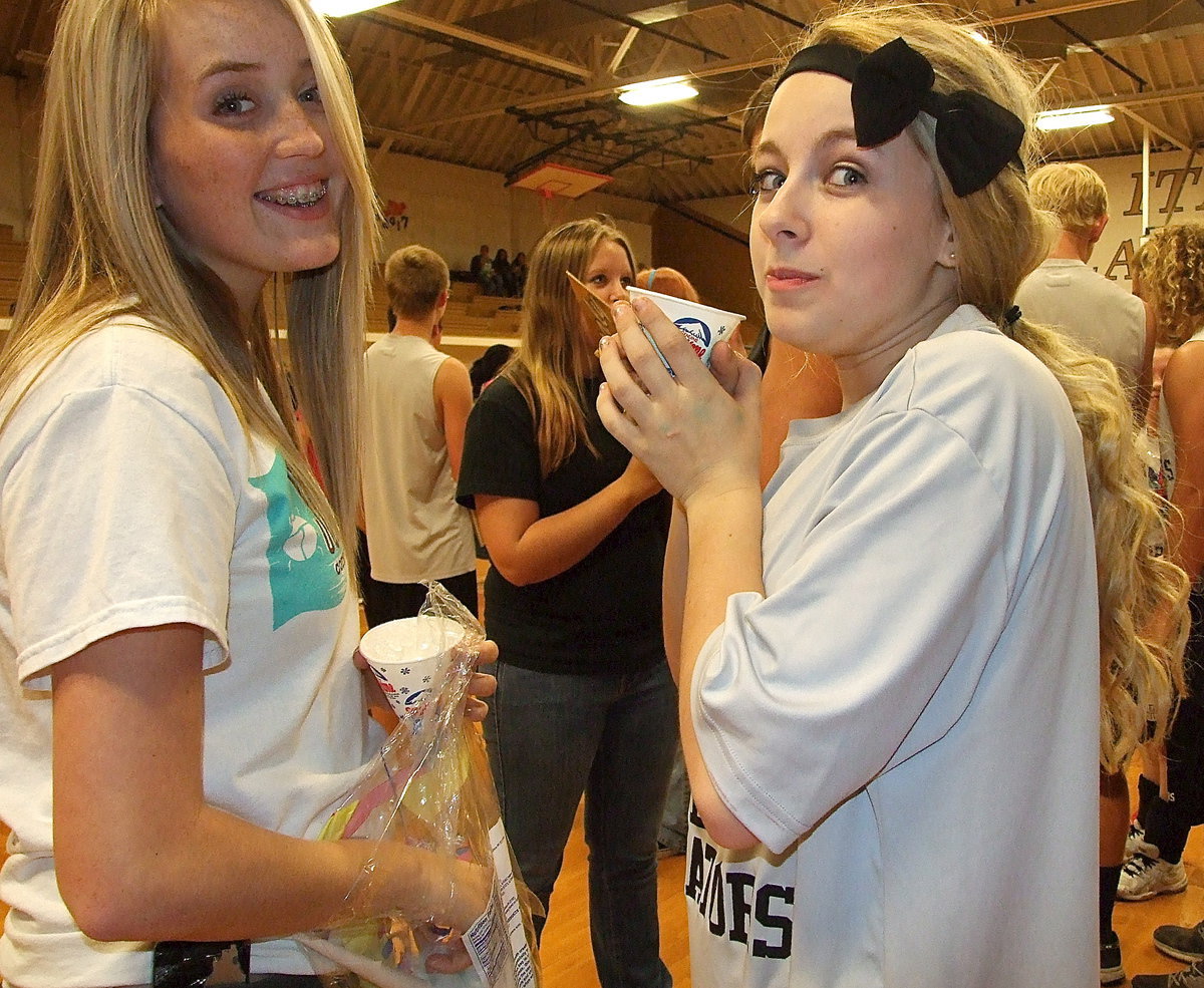 Image: Hannah Washington and Britney Chambers partake in the yearbook signing festivities while Brit sips her snow cone as if it were hot chocolate.