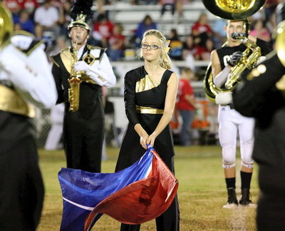 Image: Color guard captain Anna Riddle creates her on version of a wave during the halftime performance by the Gladiator Regiment Marching Band.