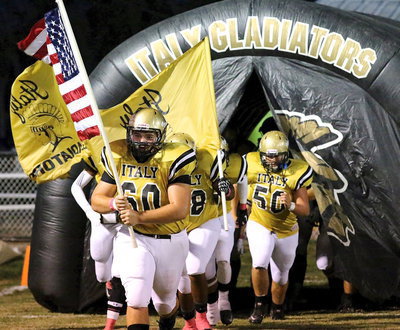 Image: Kevin Roldan(60), Darol Mayberry(58) and Zain Byers(50) charge out of the tunnel hunting for Tigers.
