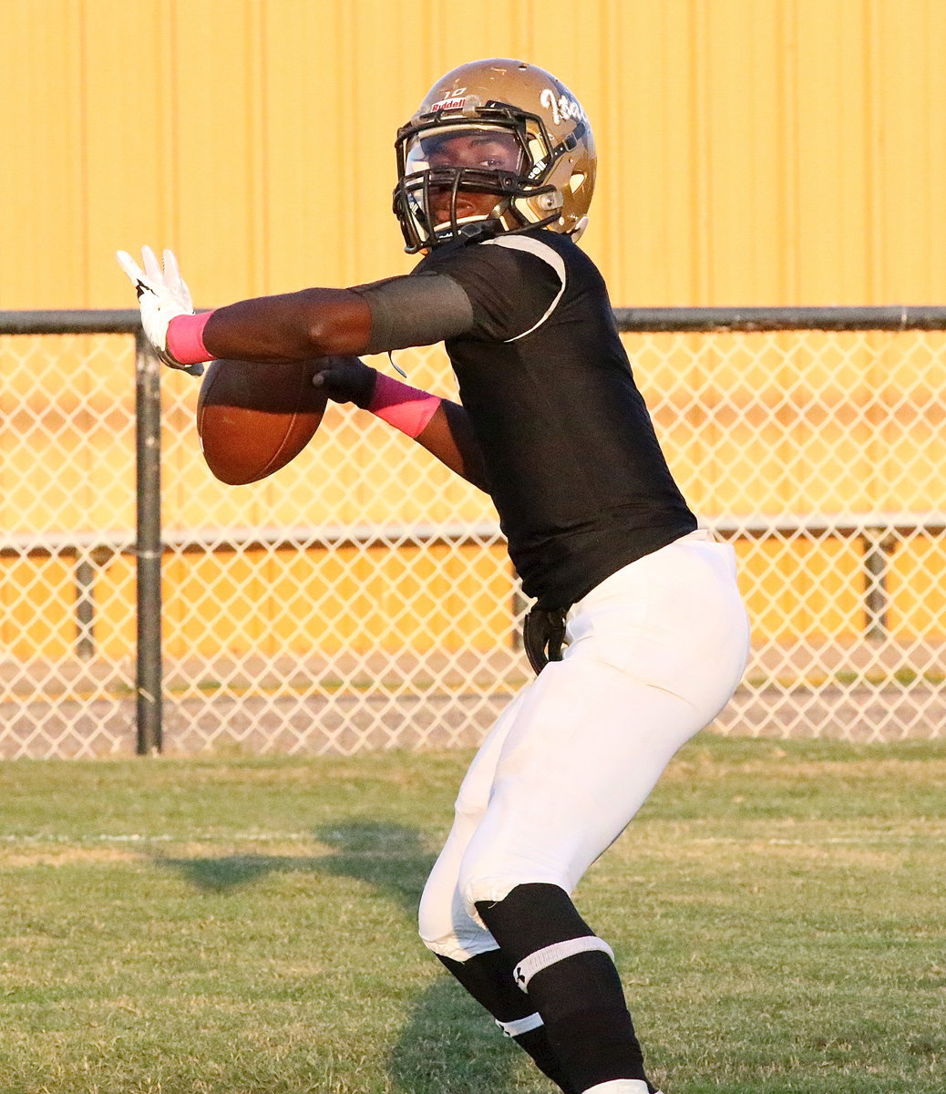 Image: Italy quarterback/running back TaMarcus Sheppard warms up his passing arm before the game against Hico.