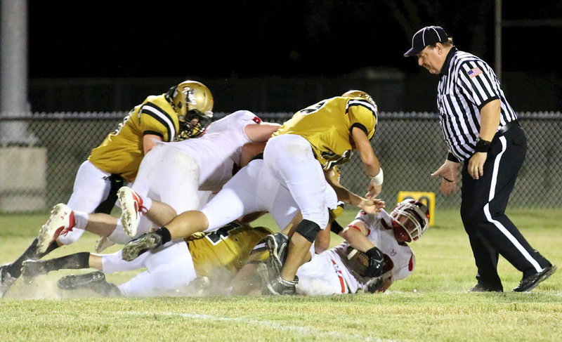 Image: Justin Wood(4) gets help from Cody Medrano(75), Zain Byes(50) and Kyle Fortenberry(66) to catch a Tiger ball carrier.