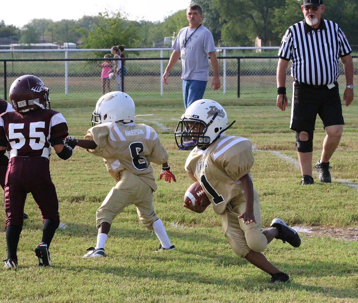 Image: Curtis Benson(1) gets a seal block from teammate Devin Anderson(8) which allowed Benson to get the edge and run for a long gain against Mildred.