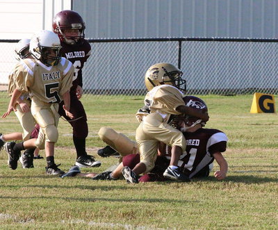 Image: Cory “Lucky” Johnson(19) helps bring down an Eagle runner with Damien Wooldridge(5) hustling over.