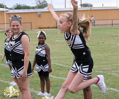 Image: IYAA B-team cheerleader Madelyn Chambers leaps high during her intro.