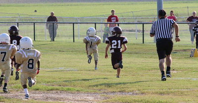 Image: C-team’s Curtis Benson(1) makes his family proud as he breaks for a long touchdown run against the Eagles.