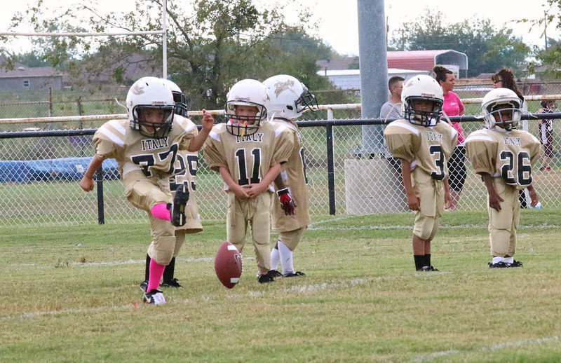 Image: Christian Posey(77) kicks off for the C-team who seems anxious to go make a tackle.