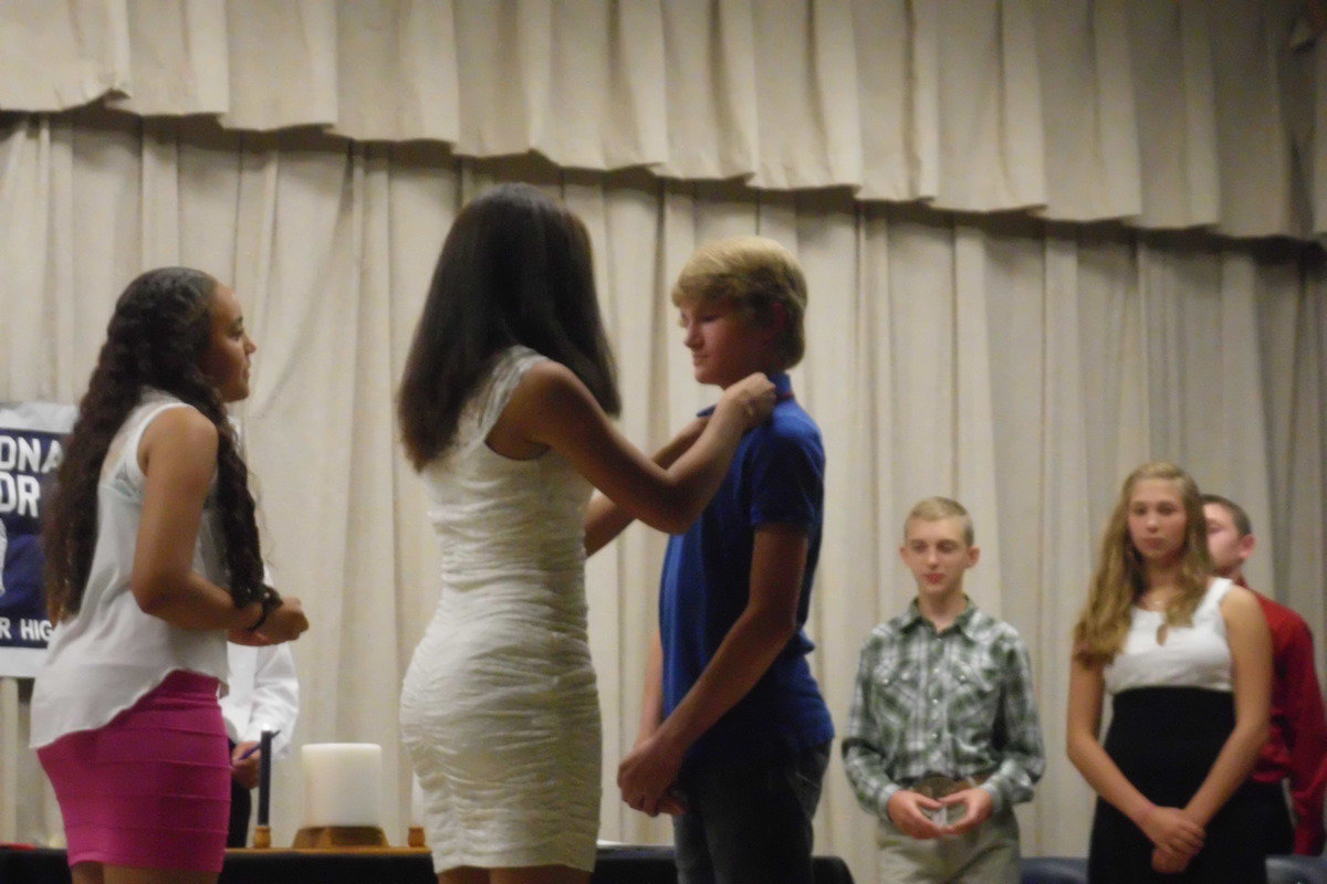 Image: Garrett Janek receives his pin from April Lusk.