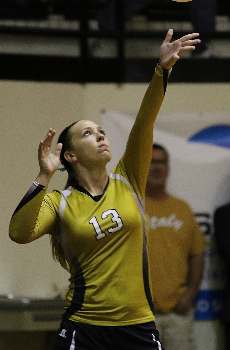 Image: With her father, Russ Lewis, looking on from the baseline, junior Lady Gladiator, Jaclynn Lewis, serves up one winner after another to Bynum.