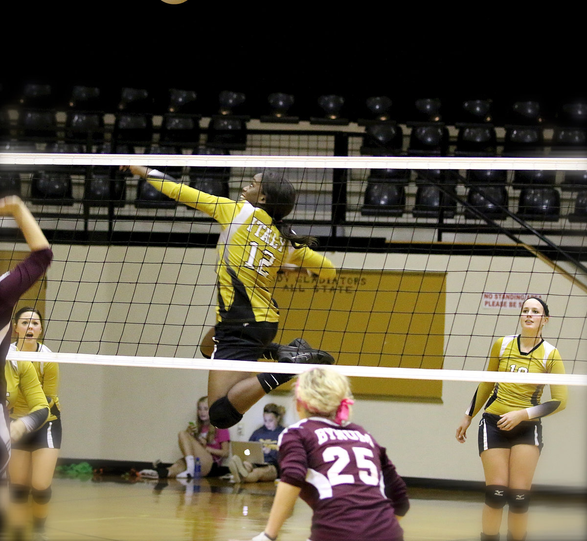 Image: Kortnei Johnson(12) skies above the Bynum defenders to score a kill shot.