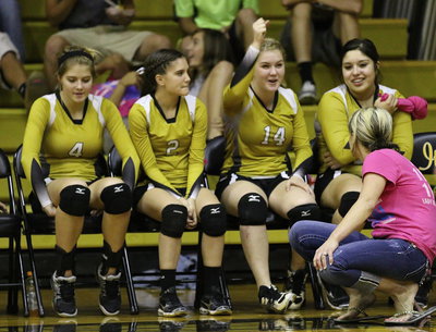 Image: Winning is fun! Halee Turner(4), Cassidy Childers(2), Taylor Turner(14) and Monserrat Figueroa(15) cheer on their teammates along with head coach Morgan Mathews.