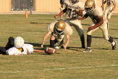 Image: Defensive end Clay Riddle(60) recovers a fumble for the Italy Junior High team.