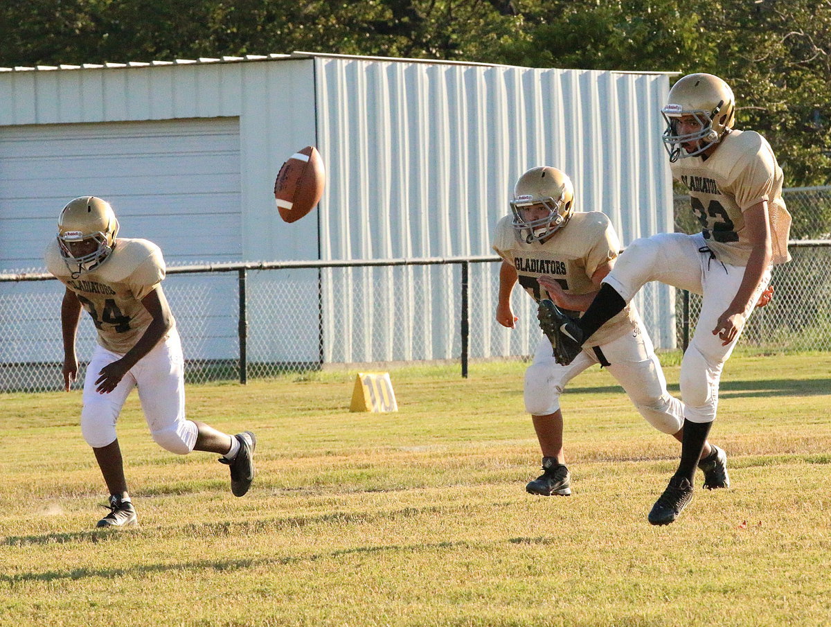 Image: Italy Junior High Gladiator Jonathan Salas(22) kicks off to the Itasca Wampus Cats to begin district play as teammates Byron Lusk, Jr.,(24) and Alex Garcia(75) head upfield to make the tackle.