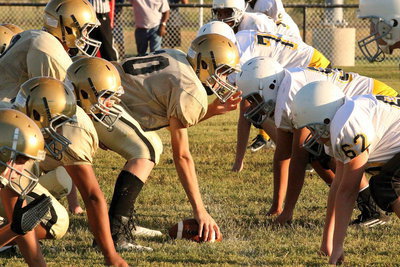 Image: Center Clay Riddle(60) leads the offensive line charge for the Junior High Gladiators. Their backs are straight and their eyes are up—that’s how you get the job done.