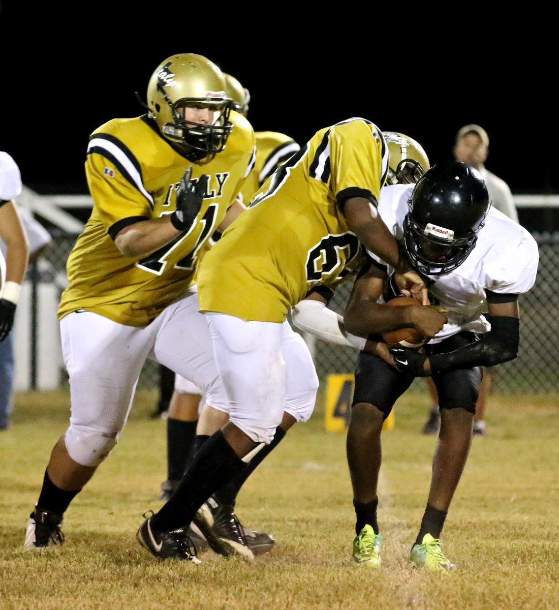 Image: Kenneth Norwood, Jr.(63), and teammate Aaron Pittmon(71) try to end the first half with a turnover.