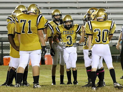 Image: Ty Windham(12) and Dylan McCasland(3) wait for the call in the huddle along with their teammates Aaron Pittman(71), Hunter Ballard(30) and the rest of the fellas.