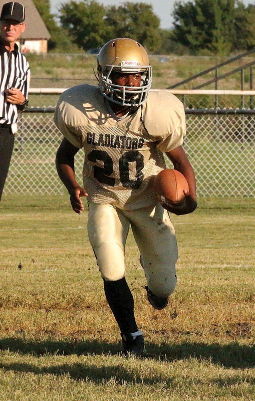 Image: Kendrick Norwood(20) tears up the Willis Field turf on his way to another big game running the ball for Italy’s junior high.