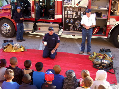 Image: Fireman Cate tells the students about fire alarms.