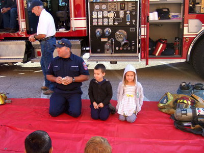 Image: Fireman Cate chose Tommy and Charlie to help demonstrate fire safety.