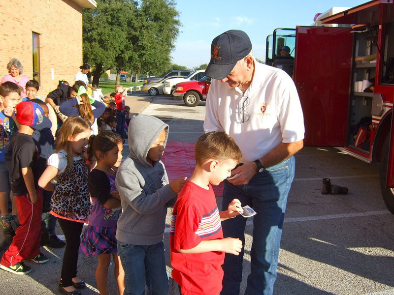 Image: Italy Fire Chief Donald Chambers passes out badge stickers to all the students.