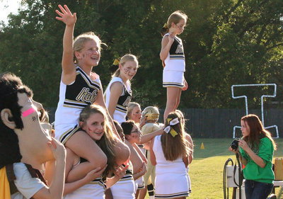 Image: Yearbook photographer Paige Little (bottom right) tries to catch our spirited cheerleaders in action.