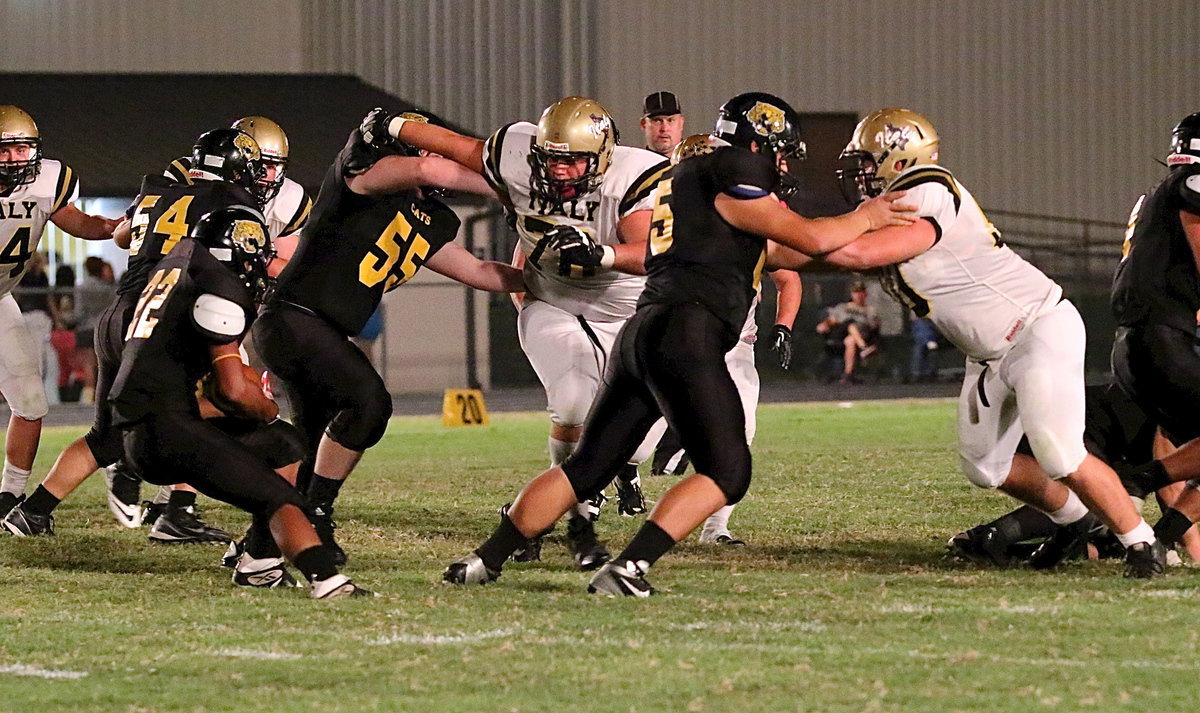 Image: Defensive end Zain Byers(50) turns an Itasca ball carrier back inside where teammates Bailey Walton(54), John Byers(56) and Colin Newman(76) are waiting.