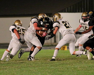 Image: Linebacker Kyle Fortenberry(66) and safety Ryan Connor(21) collar a Wampus Cat.