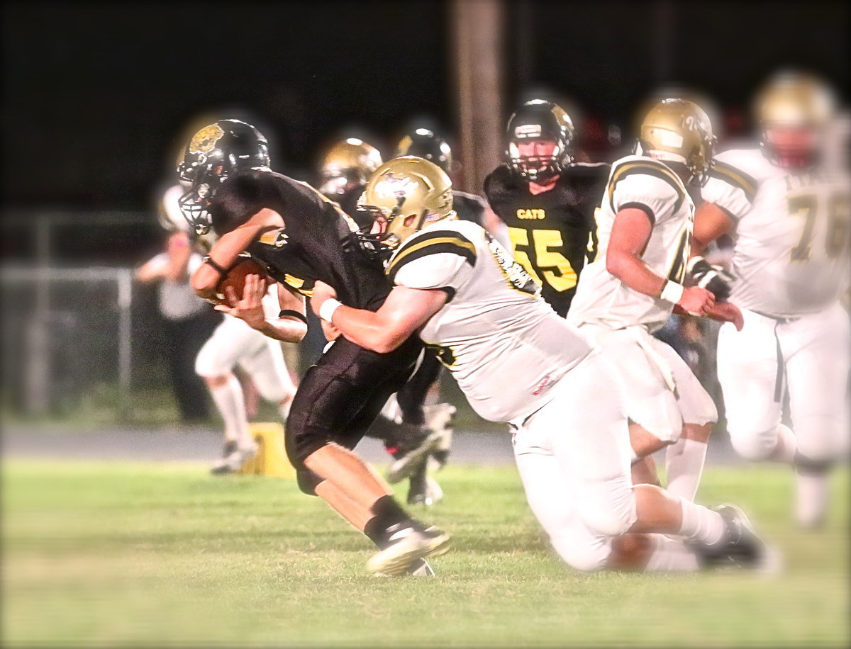 Image: Junior defensive tackle John Byers(56) brings down Itasca’s quarterback.