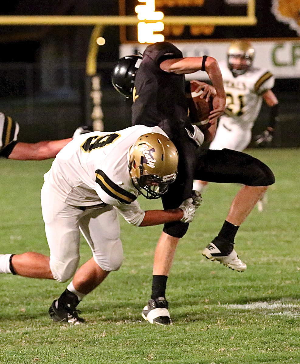 Image: Hunter Merimon(9) puts the hurt on an Itasca receiver.