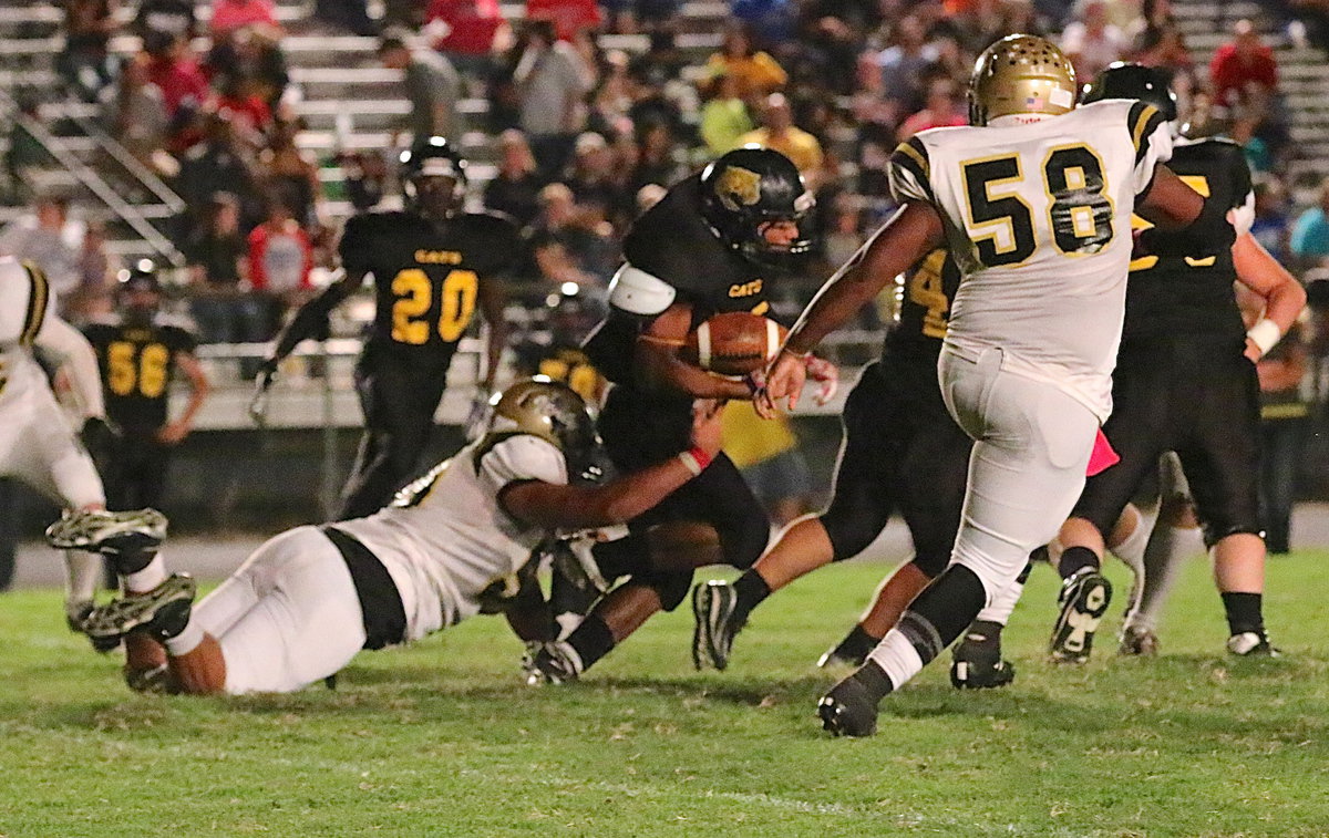 Image: From his defensive end position, Zain Byers(50) tackles Itasca’s receiver after a pass to the opposite side of the field only netted the Cats 3 yards.