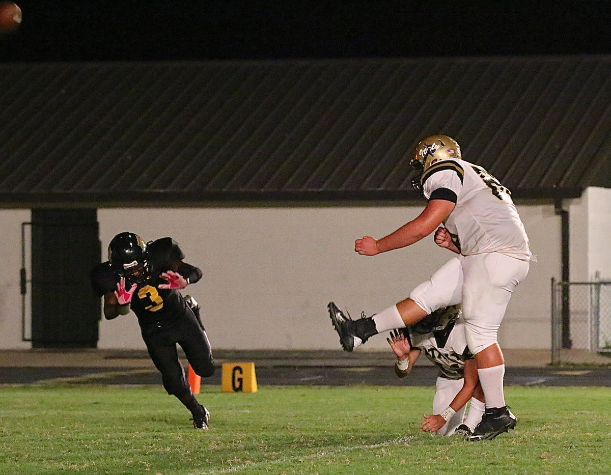 Image: Kevin Roldan(60) boots thru a point-after kick with Tyler Anderson(11) holding. Roldan made 4-of-6 P.A.T.s for the Gladiators.