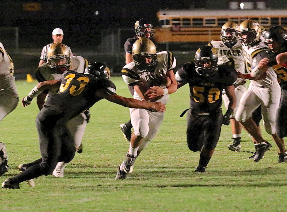 Image: Italy senior quarterback Tyler Anderson(11) fights thru defenders for a big gain.