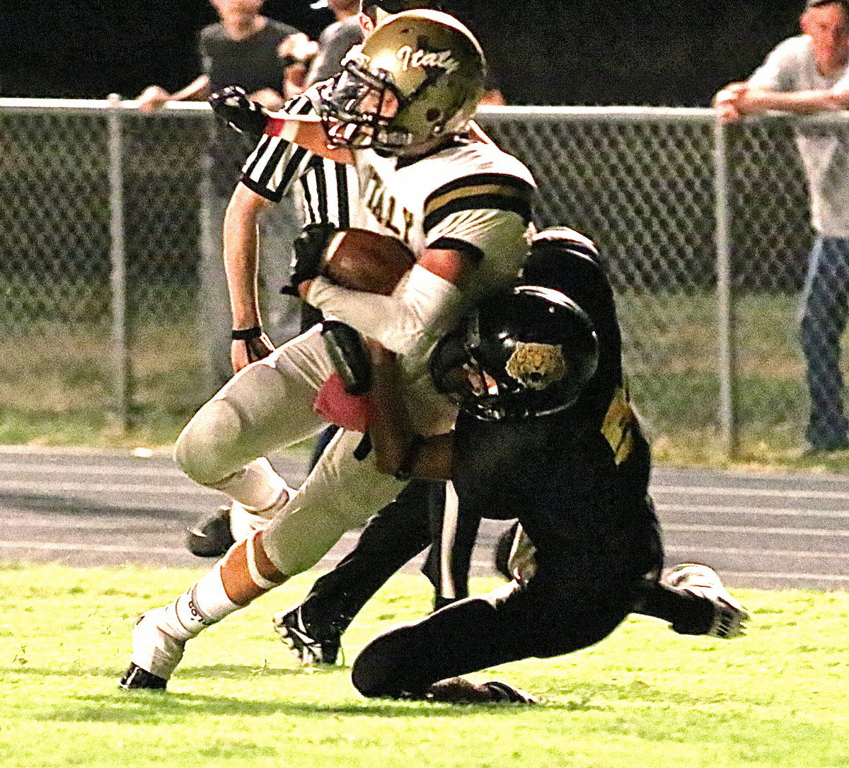 Image: Receiver Levi McBride(1) is finally brought down by an Itasca defender after McBride turns in a big play for Italy.