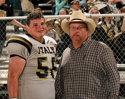 Image: Inside defensive tackle for the Gladiators John Byers(56) stands with his proud father Brentley Byers after Italy’s win over Itasca.