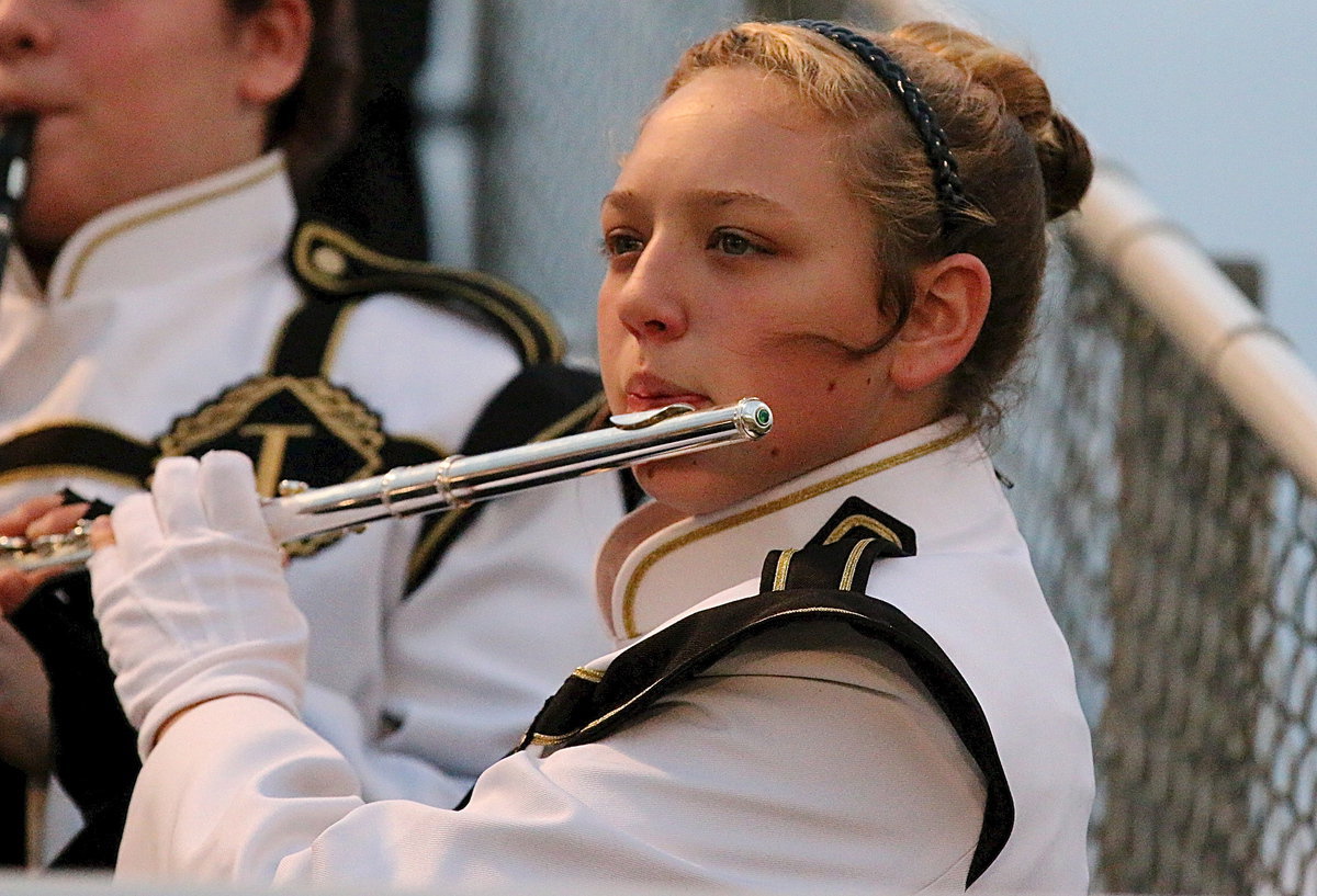 Image: Gladiator Regiment Band member Brycelen Richards plays her flute from the stands.