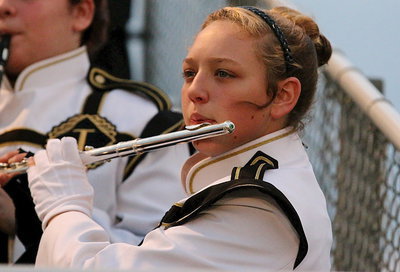 Image: Gladiator Regiment Band member Brycelen Richards plays her flute from the stands.