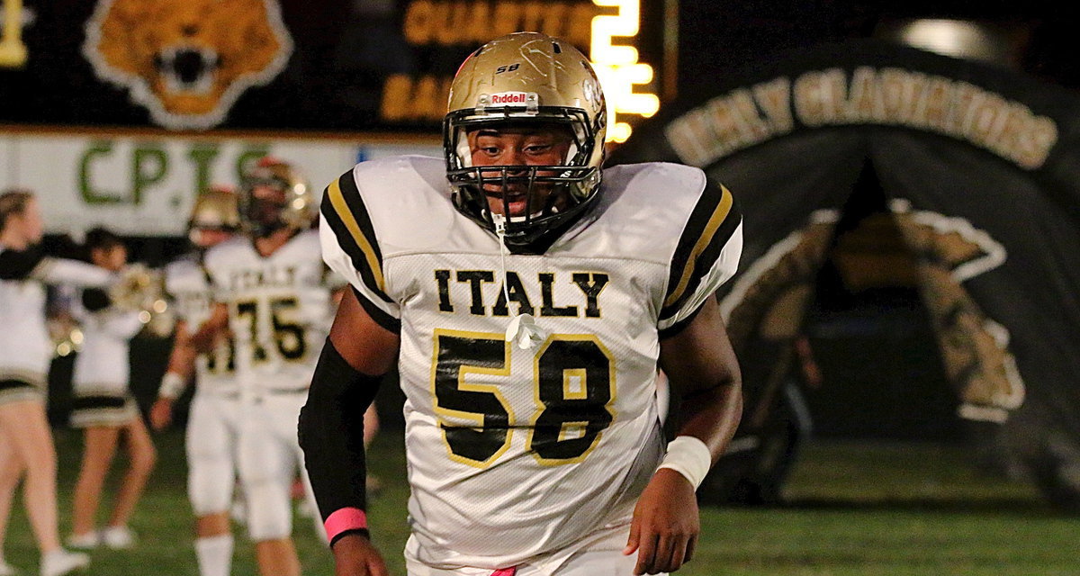 Image: Senior lineman Darol Mayberry(58) storms out of the tunnel with his teammates.