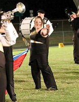 Image: Color Guard member Sarah Burrow executes her flag routine with a smile.