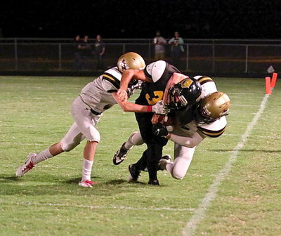 Image: Cody Boyd(15) gets help from Clayton Miller(6) in order to bring down a Wampus Cat during a kick return.