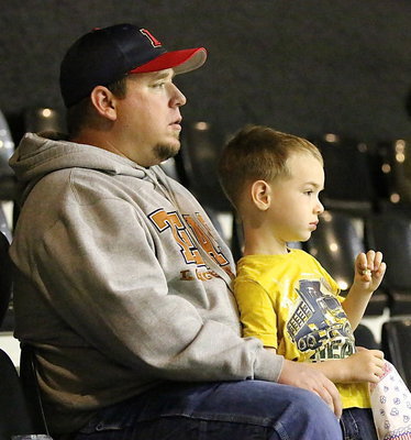 Image: Lady Gladiator fan Scott Connor and son Trent enjoy volleyball and popcorn from the upper deck of Italy Coliseum.