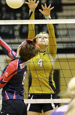 Image: Halee Turner(4) tries to win the battle above the net.