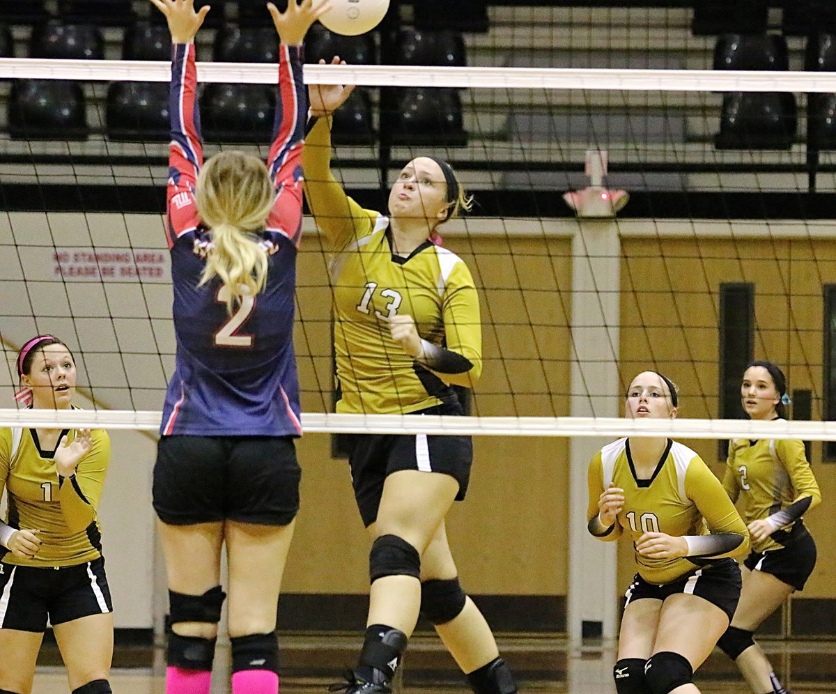 Image: Lady Gladiator junior Jaclynn Lewis(13) attacks the net.